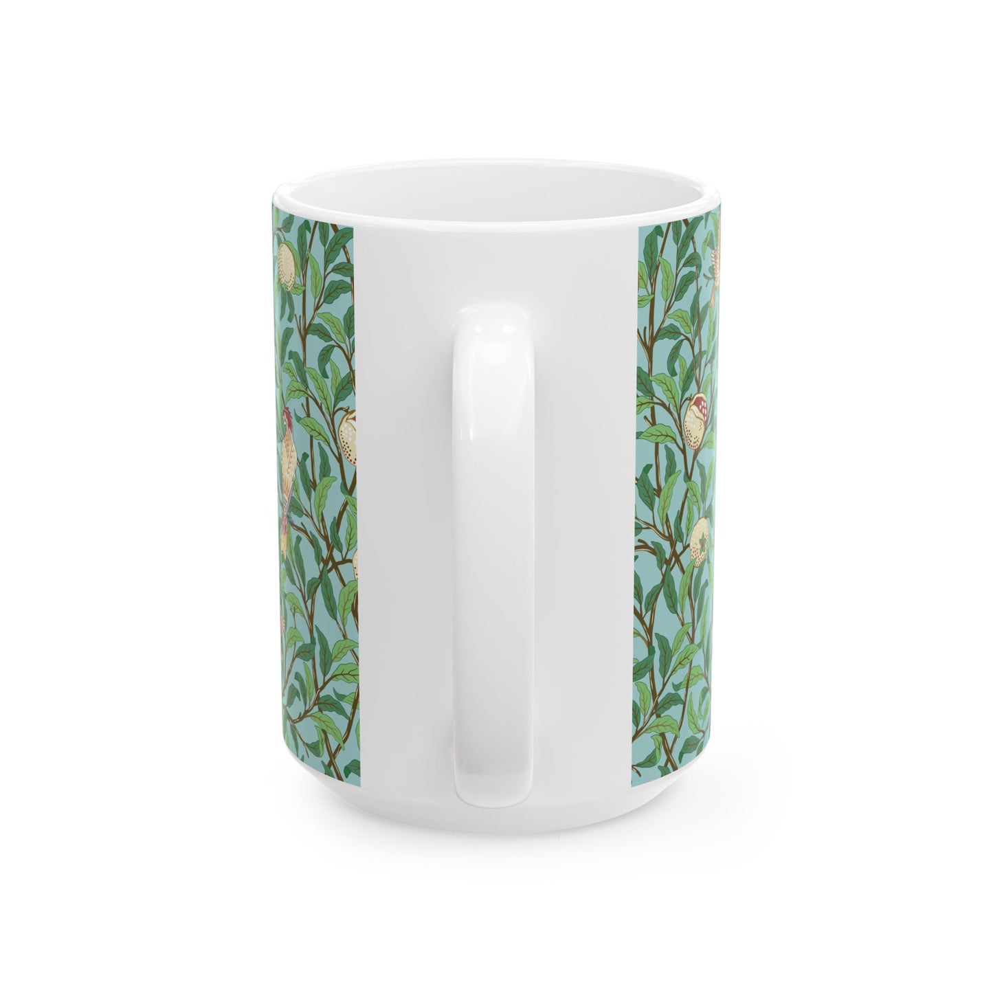 A ceramic mug with a blue background featuring a floral pattern of birds and pomegranates.