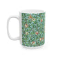 A ceramic mug with a blue background featuring a floral pattern of birds and pomegranates.