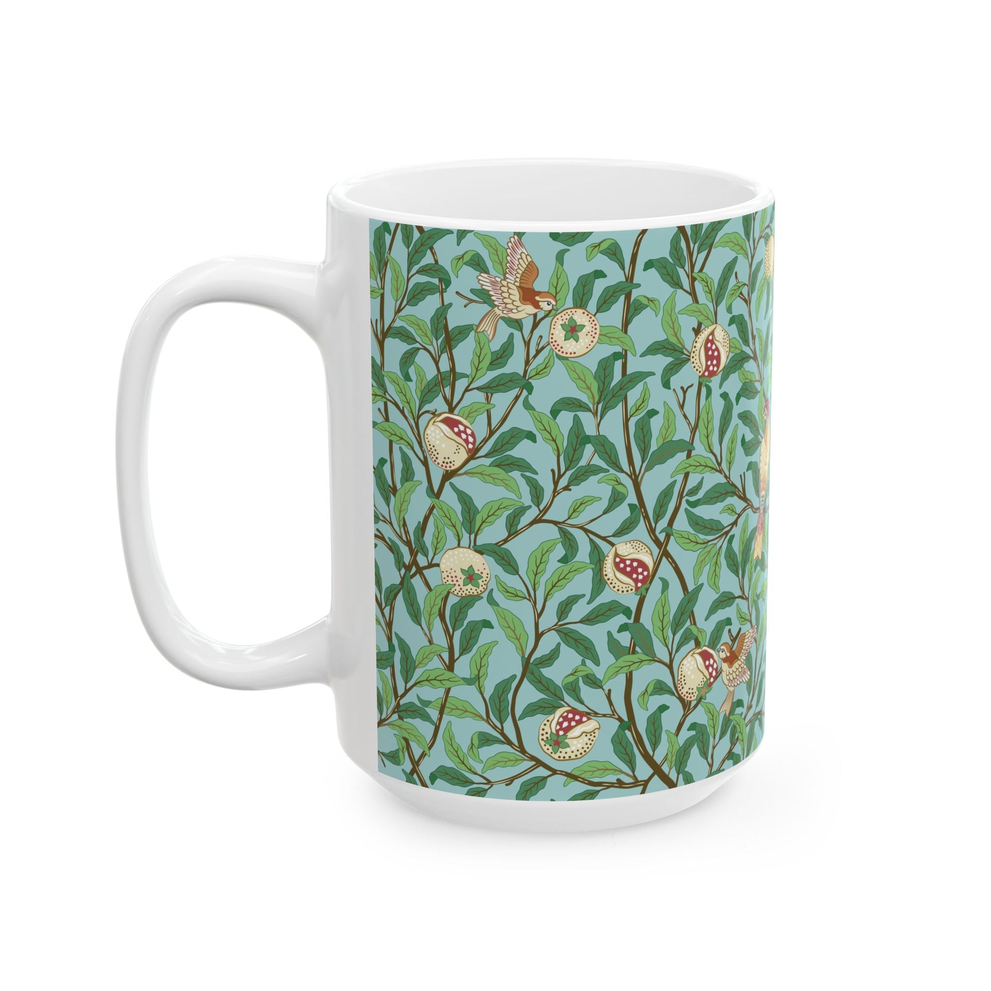 A ceramic mug with a blue background featuring a floral pattern of birds and pomegranates.
