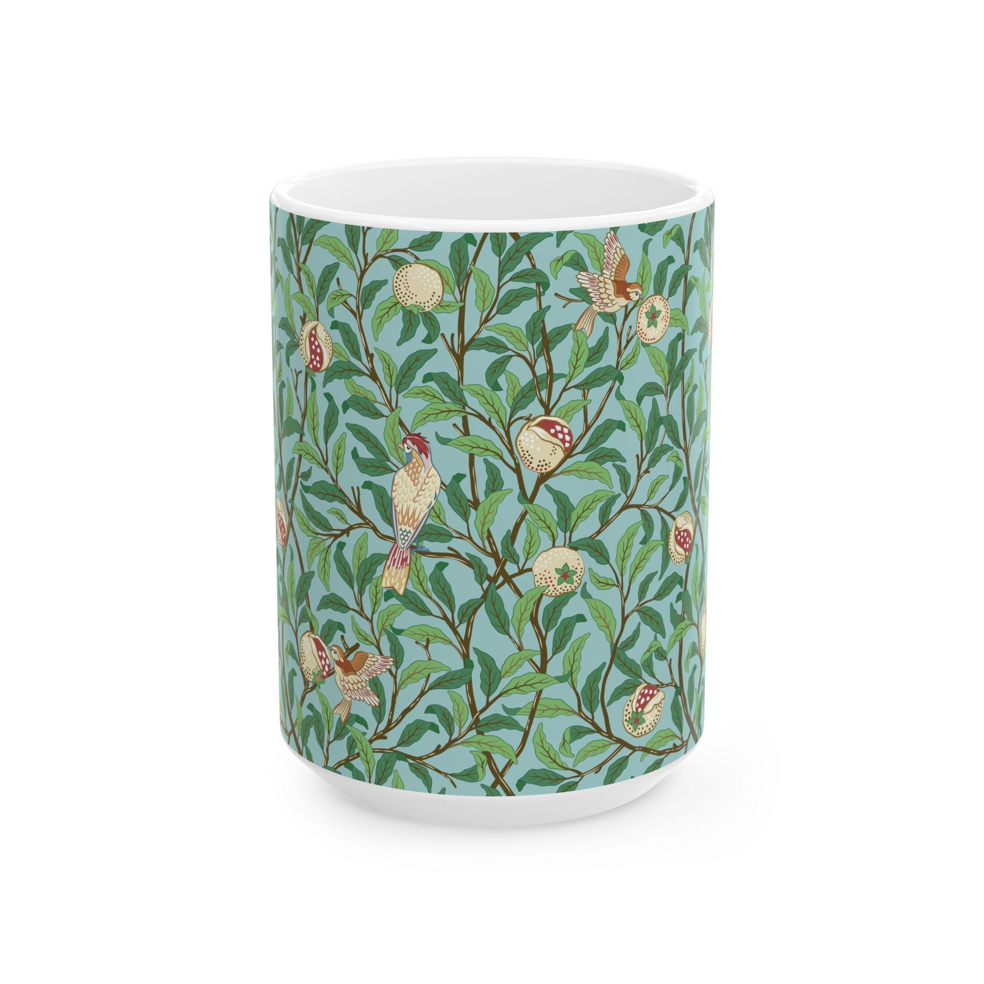 A ceramic mug with a blue background featuring a floral pattern of birds and pomegranates.