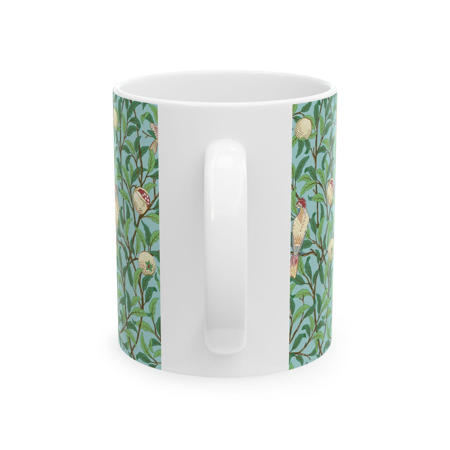 A ceramic mug with a blue background featuring a floral pattern of birds and pomegranates.