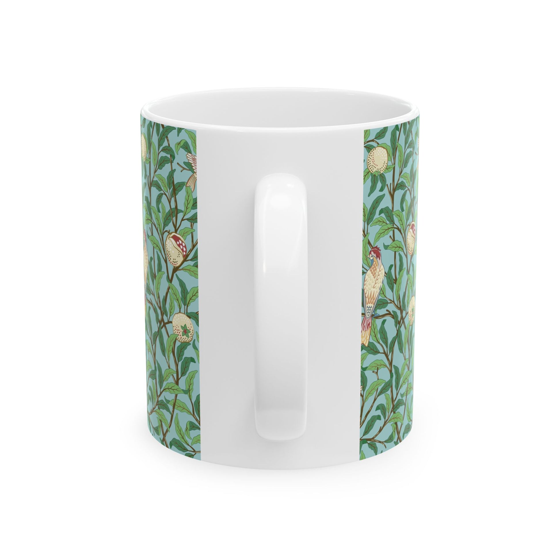 A ceramic mug with a blue background featuring a floral pattern of birds and pomegranates.