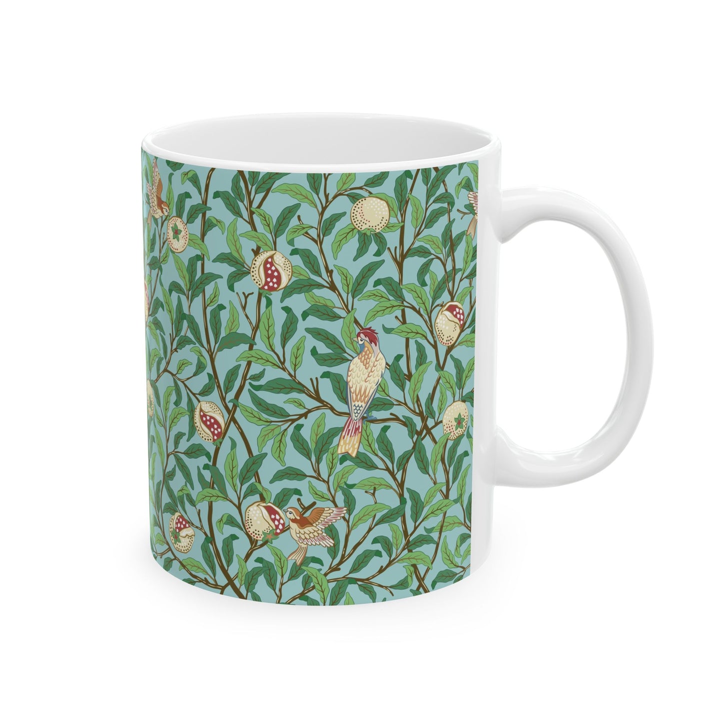 A ceramic mug with a blue background featuring a floral pattern of birds and pomegranates.