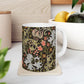 A ceramic mug with a floral pattern inspired by William Morris & Co - Golden Lily Collection in a midnight colour palette.