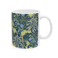 A white ceramic mug with a blue and green floral pattern inspired by William Morris.