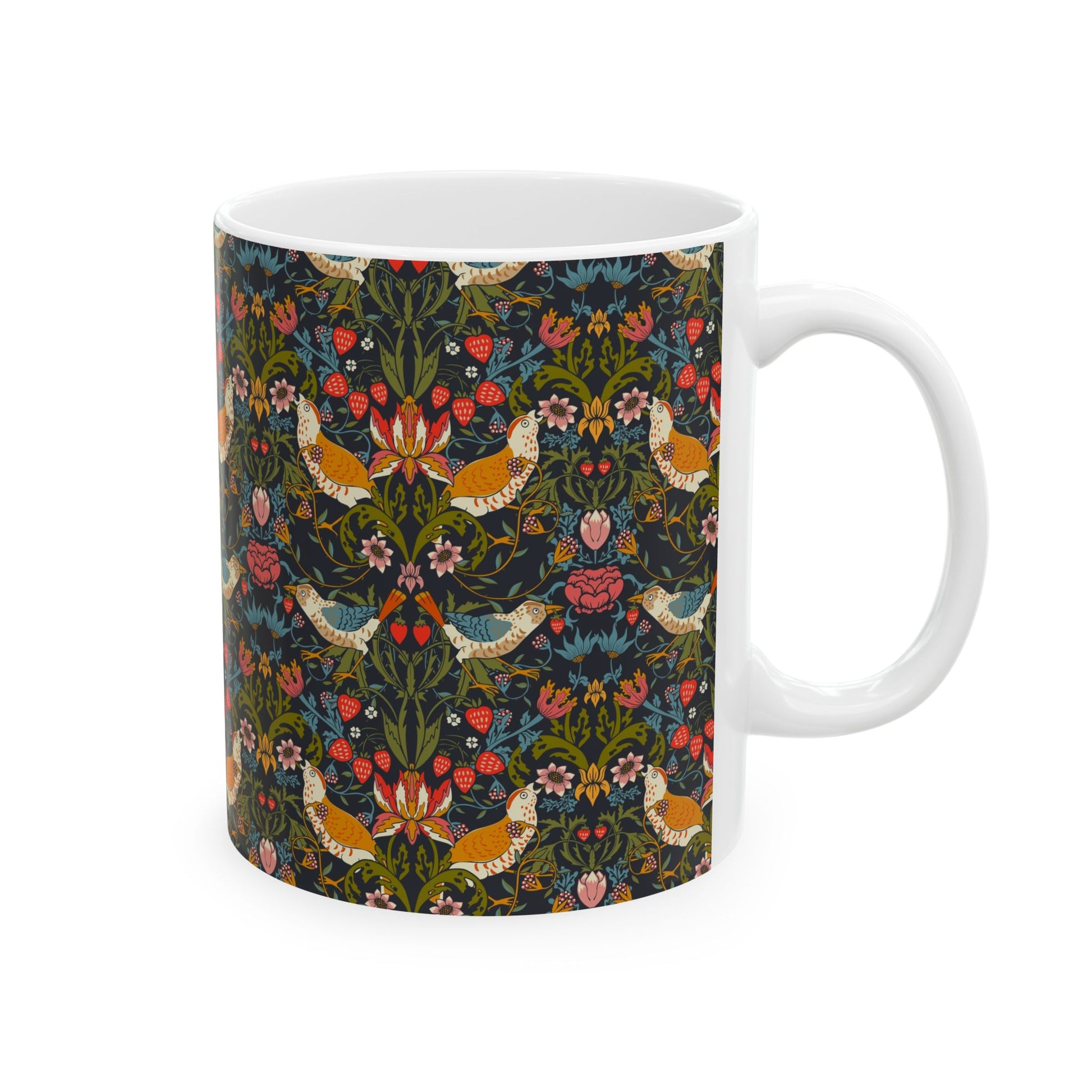 A ceramic mug with a colorful floral pattern and birds, inspired by William Morris' Strawberry Thief collection.