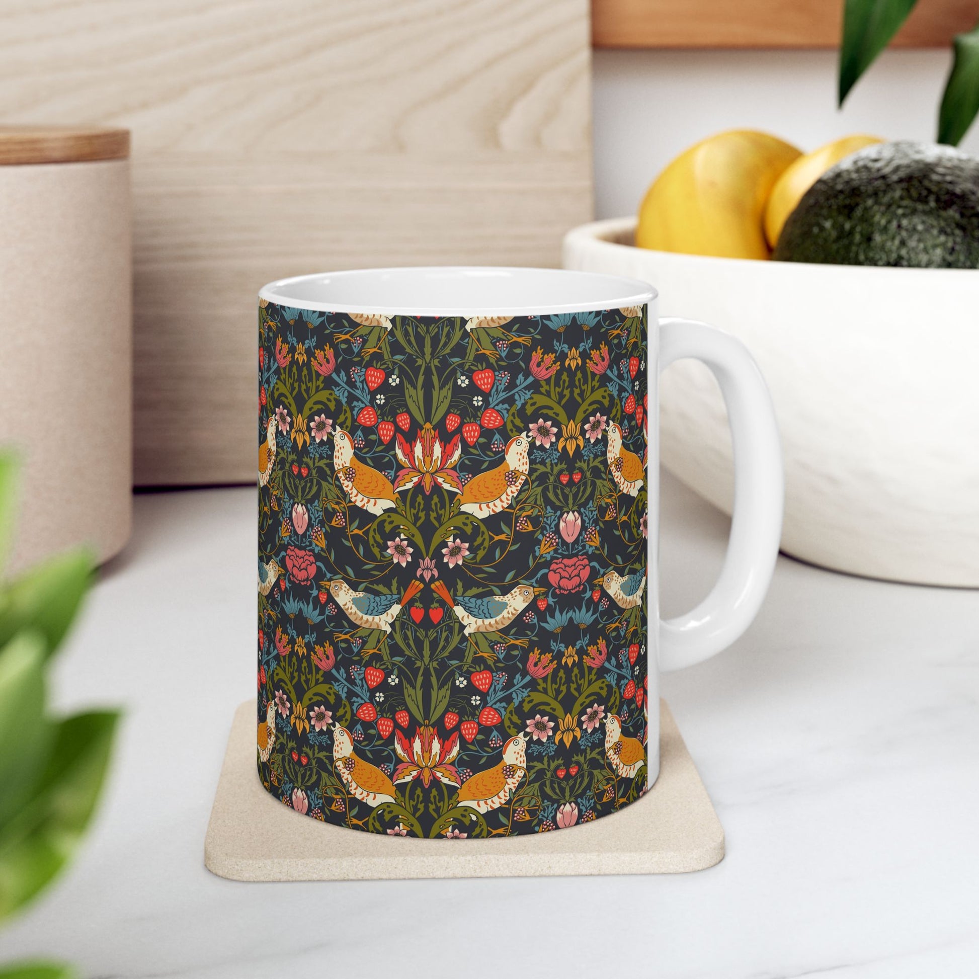 Mug with floral and bird pattern on a kitchen counter.