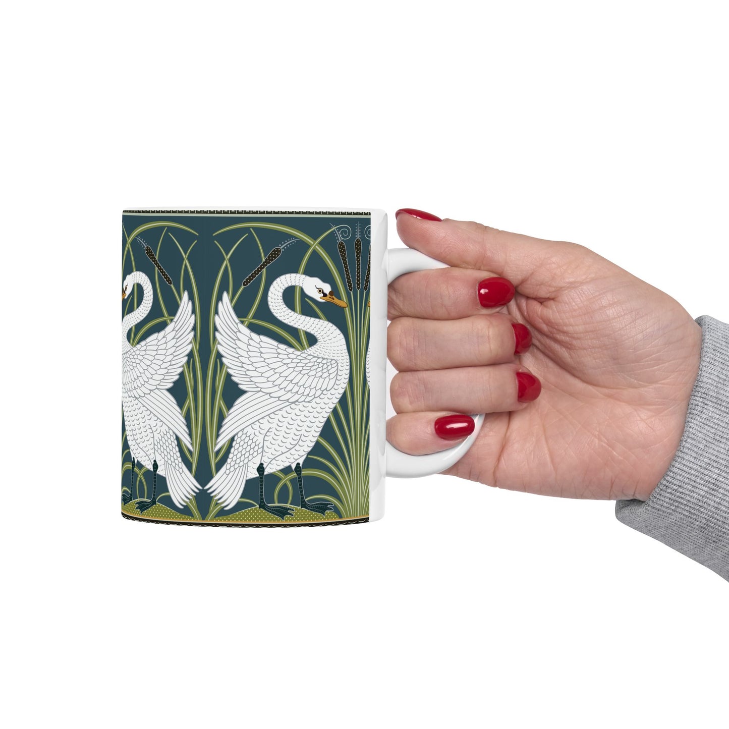 A ceramic mug with a design of two white swans on a green and blue background, inspired by the art of William Morris.