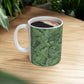 A ceramic mug with a green and white leaf pattern inspired by William Morris - Acanthus Collection.