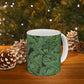 A ceramic mug with a green and white leaf pattern inspired by William Morris - Acanthus Collection.