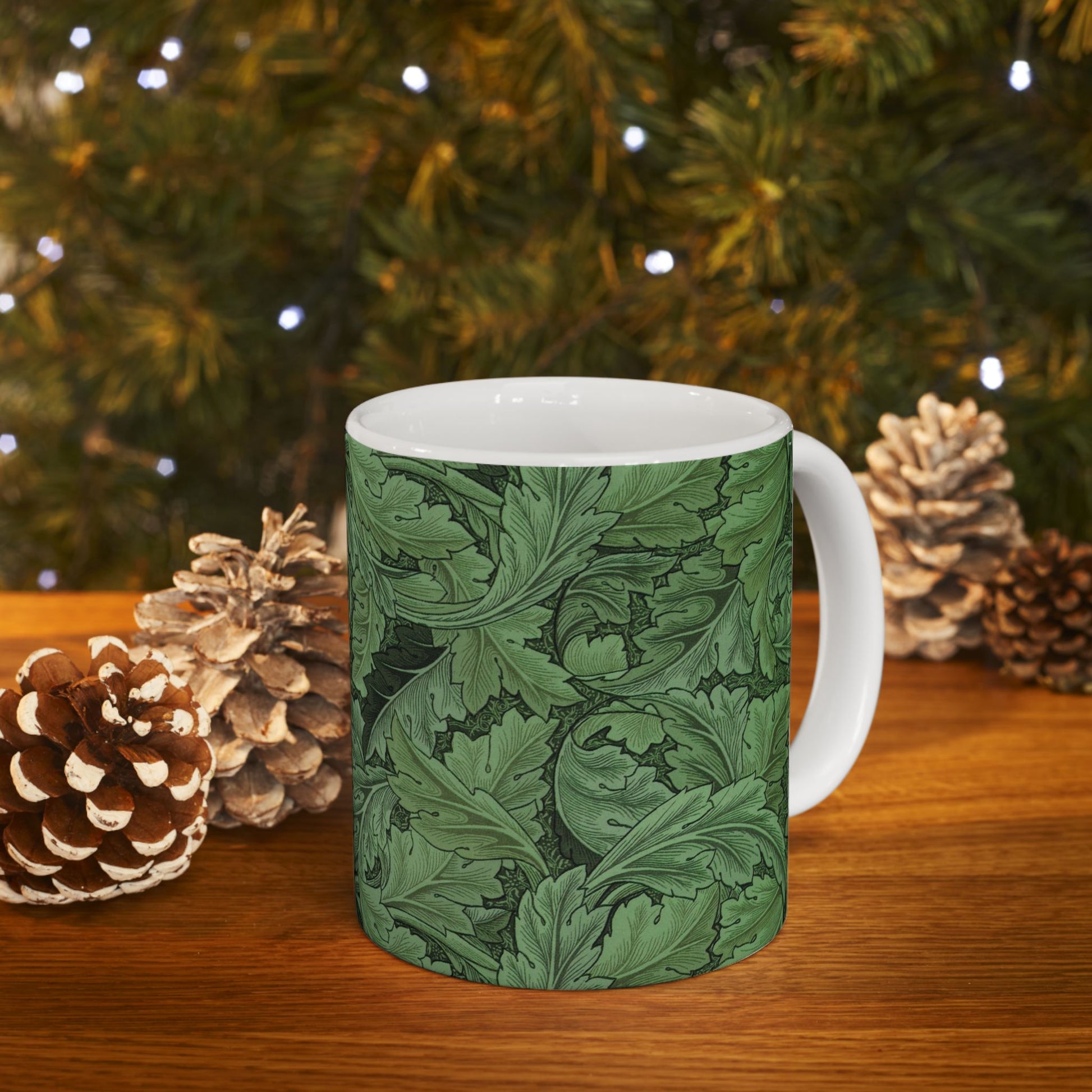A ceramic mug with a green and white leaf pattern inspired by William Morris - Acanthus Collection.