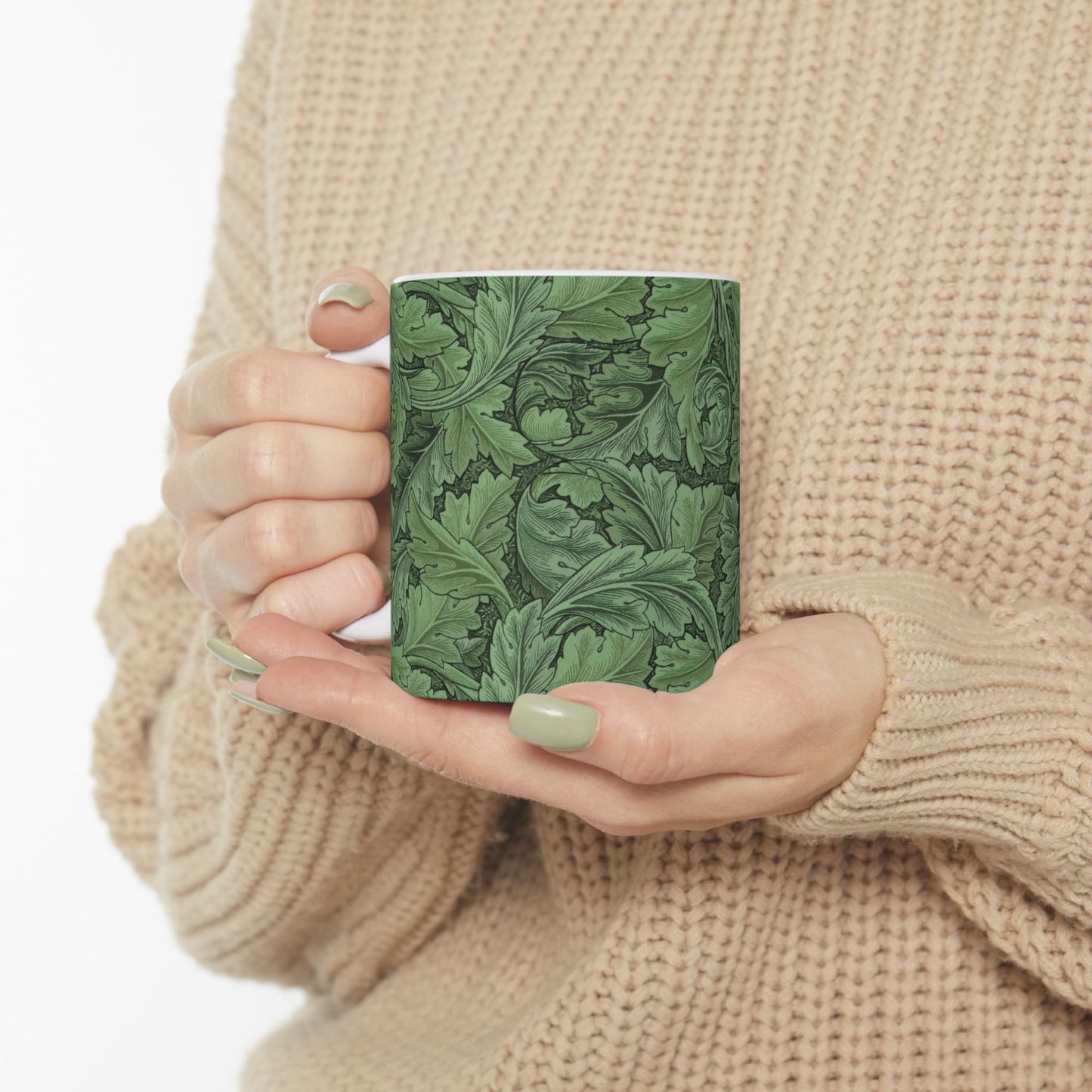 A ceramic mug with a green and white leaf pattern inspired by William Morris - Acanthus Collection.