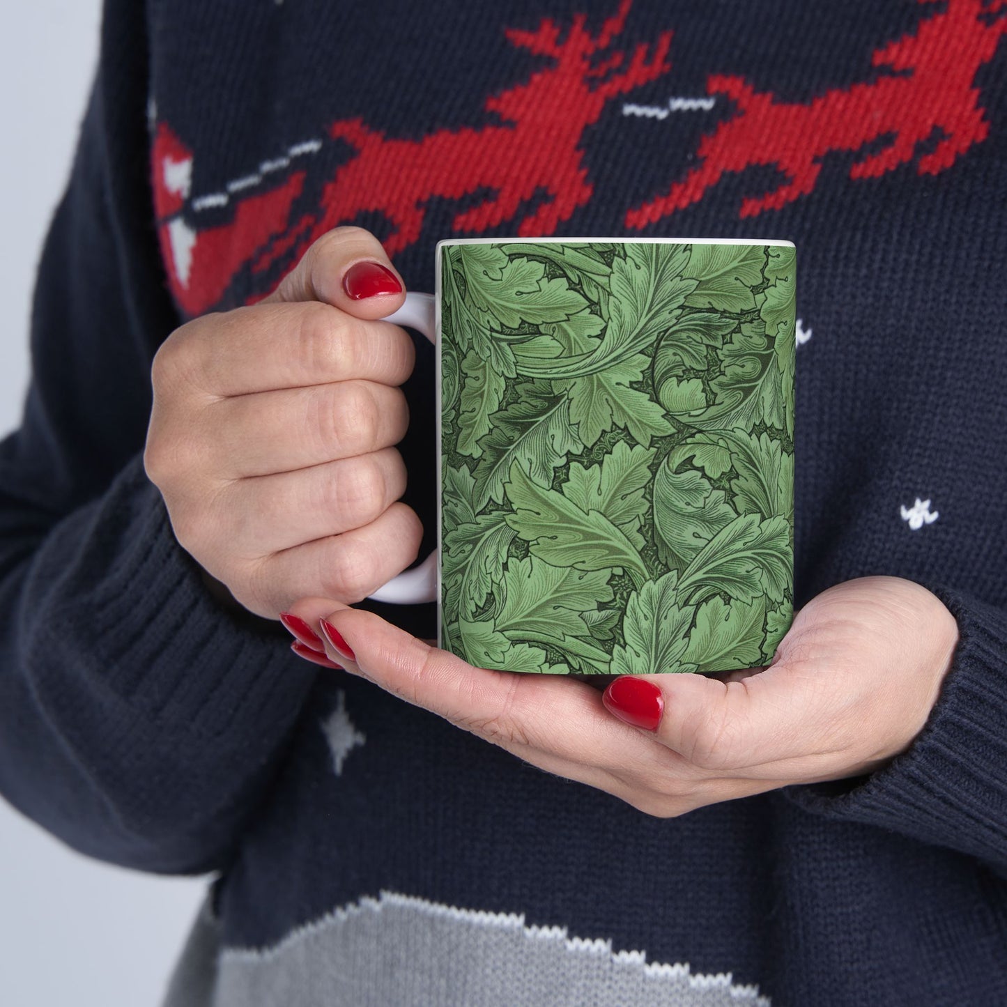 A ceramic mug with a green and white leaf pattern inspired by William Morris - Acanthus Collection.