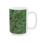 A ceramic mug with a green and white leaf pattern inspired by William Morris - Acanthus Collection.