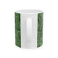 A ceramic mug with a green and white leaf pattern inspired by William Morris - Acanthus Collection.