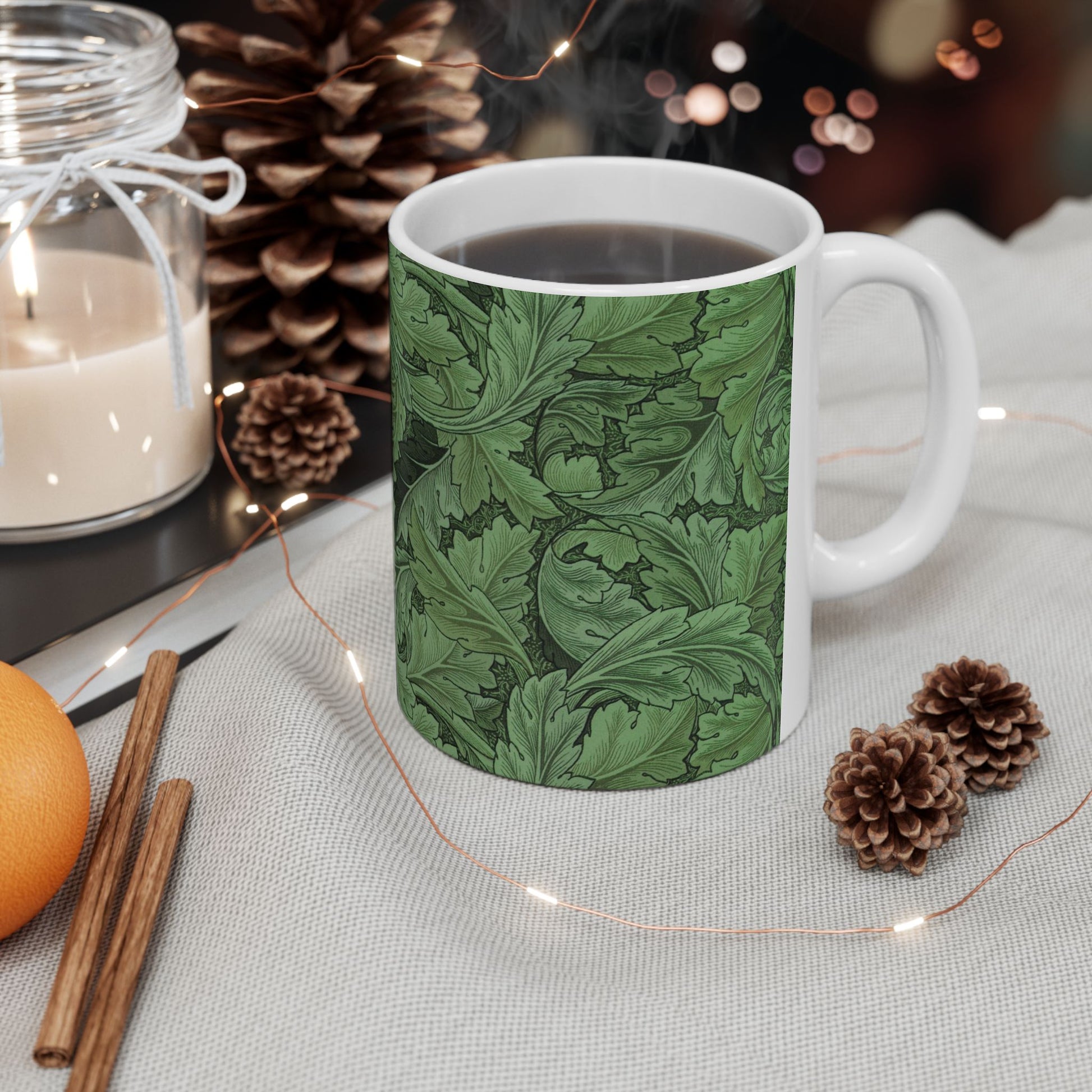 A ceramic mug with a green and white leaf pattern inspired by William Morris - Acanthus Collection.