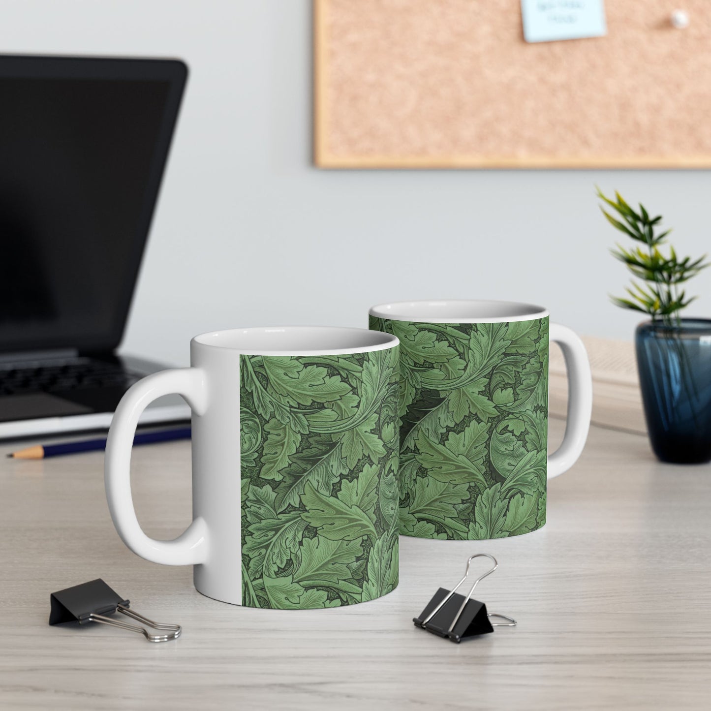 A ceramic mug with a green and white leaf pattern inspired by William Morris - Acanthus Collection.