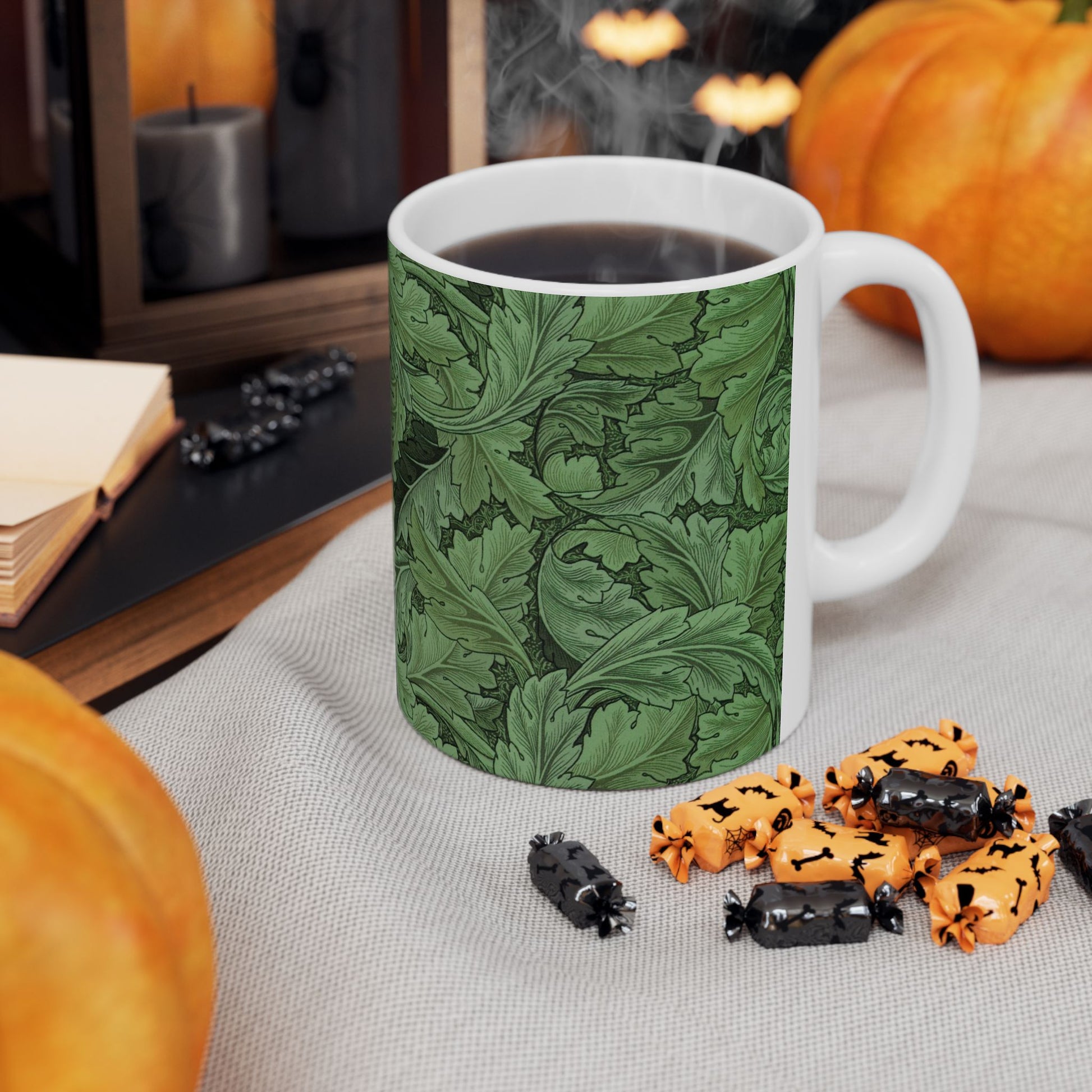 A ceramic mug with a green and white leaf pattern inspired by William Morris - Acanthus Collection.