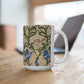 A ceramic mug with a floral William Morris & Co pattern design, featuring a bird and various flowers in shades of blue, green and beige.