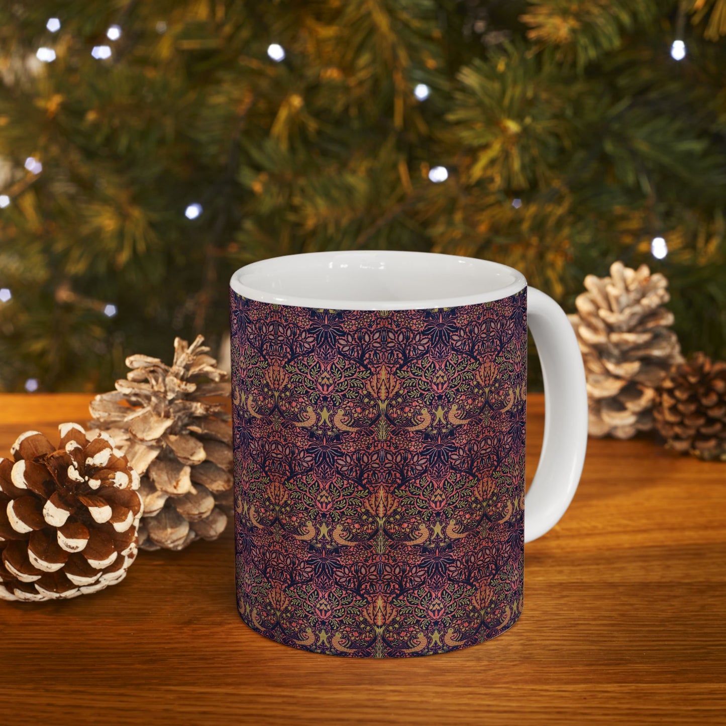 A ceramic mug with a floral pattern inspired by William Morris's artistry, featuring a white base and a shiny finish.