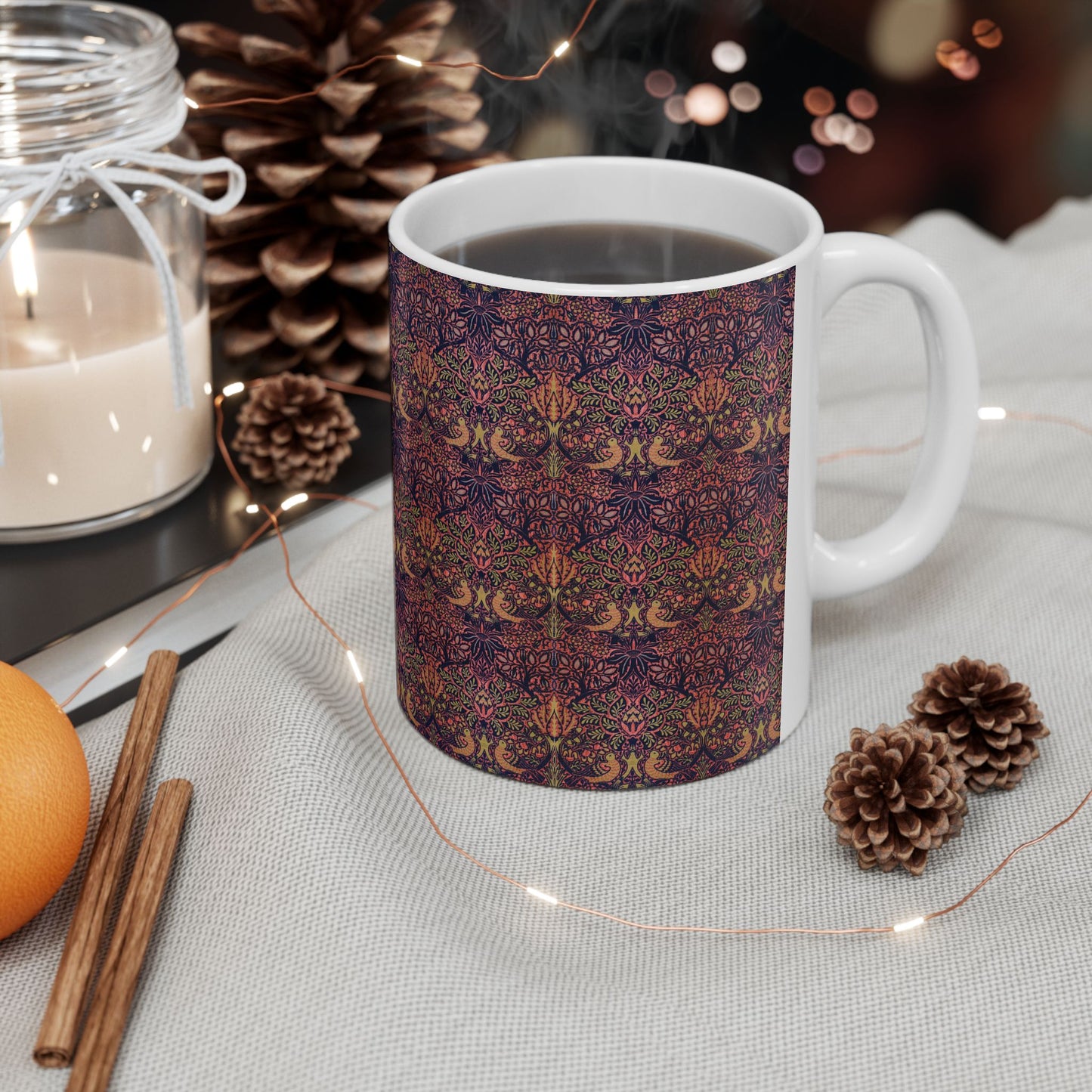 A ceramic mug with a floral pattern inspired by William Morris's artistry, featuring a white base and a shiny finish.