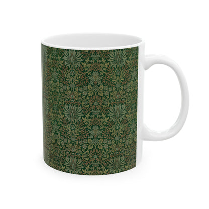 A ceramic mug with a floral garden William Morris & Co pattern design, predominantly green and white.