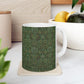A ceramic mug with a floral garden William Morris & Co pattern design, predominantly green and white.