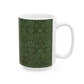 A ceramic mug with a floral garden William Morris & Co pattern design, predominantly green and white.