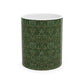 A ceramic mug with a floral garden William Morris & Co pattern design, predominantly green and white.