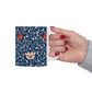 A ceramic mug with a floral pattern and a white handle featuring a blue. white, red and pink pattern design called Medway by William Morris & Co