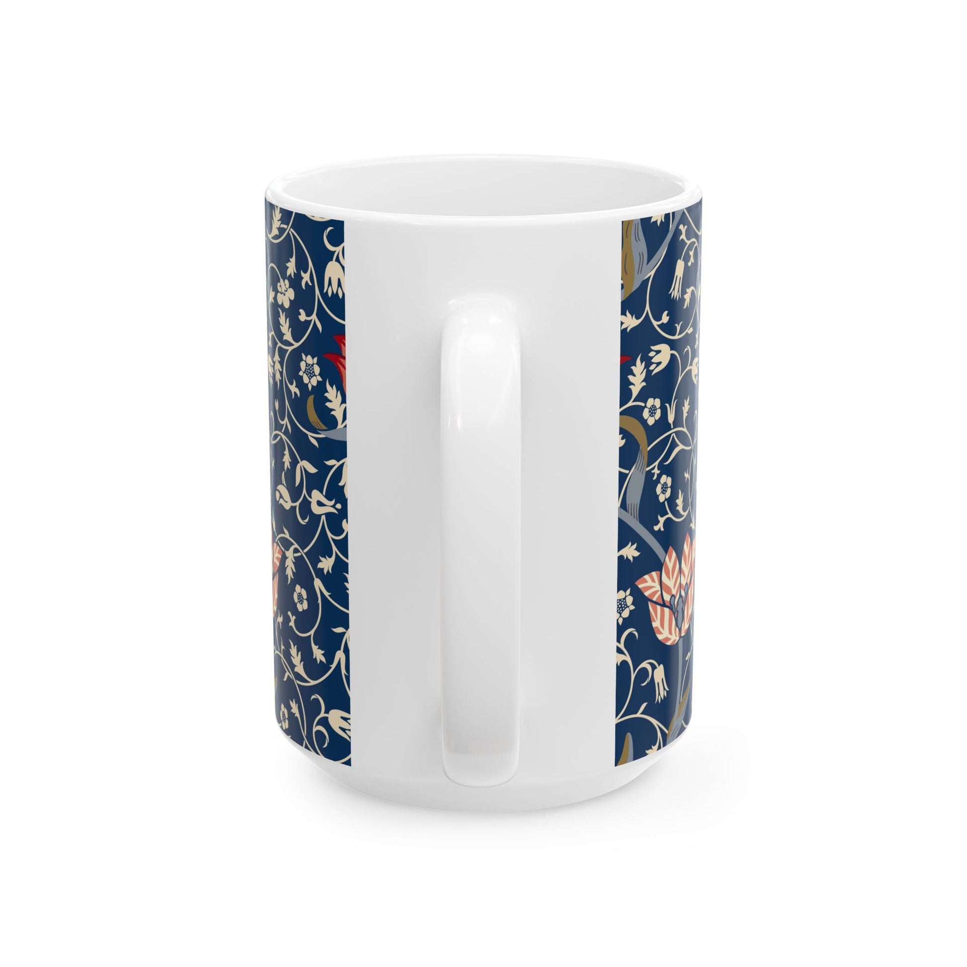 A ceramic mug with a floral pattern and a white handle featuring a blue. white, red and pink pattern design called Medway by William Morris & Co