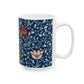 A ceramic mug with a floral pattern and a white handle featuring a blue. white, red and pink pattern design called Medway by William Morris & Co