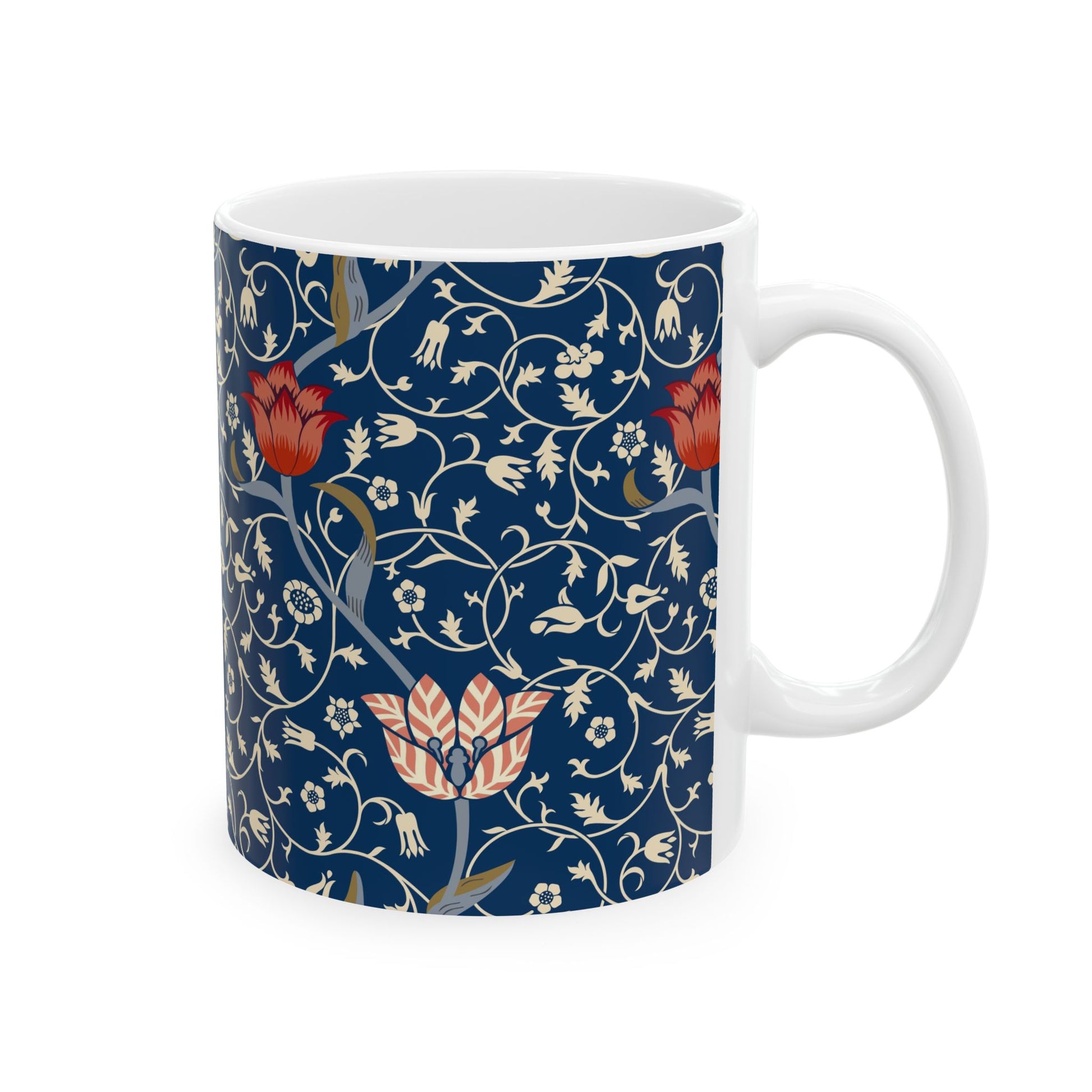 A ceramic mug with a floral pattern and a white handle featuring a blue. white, red and pink pattern design called Medway by William Morris & Co