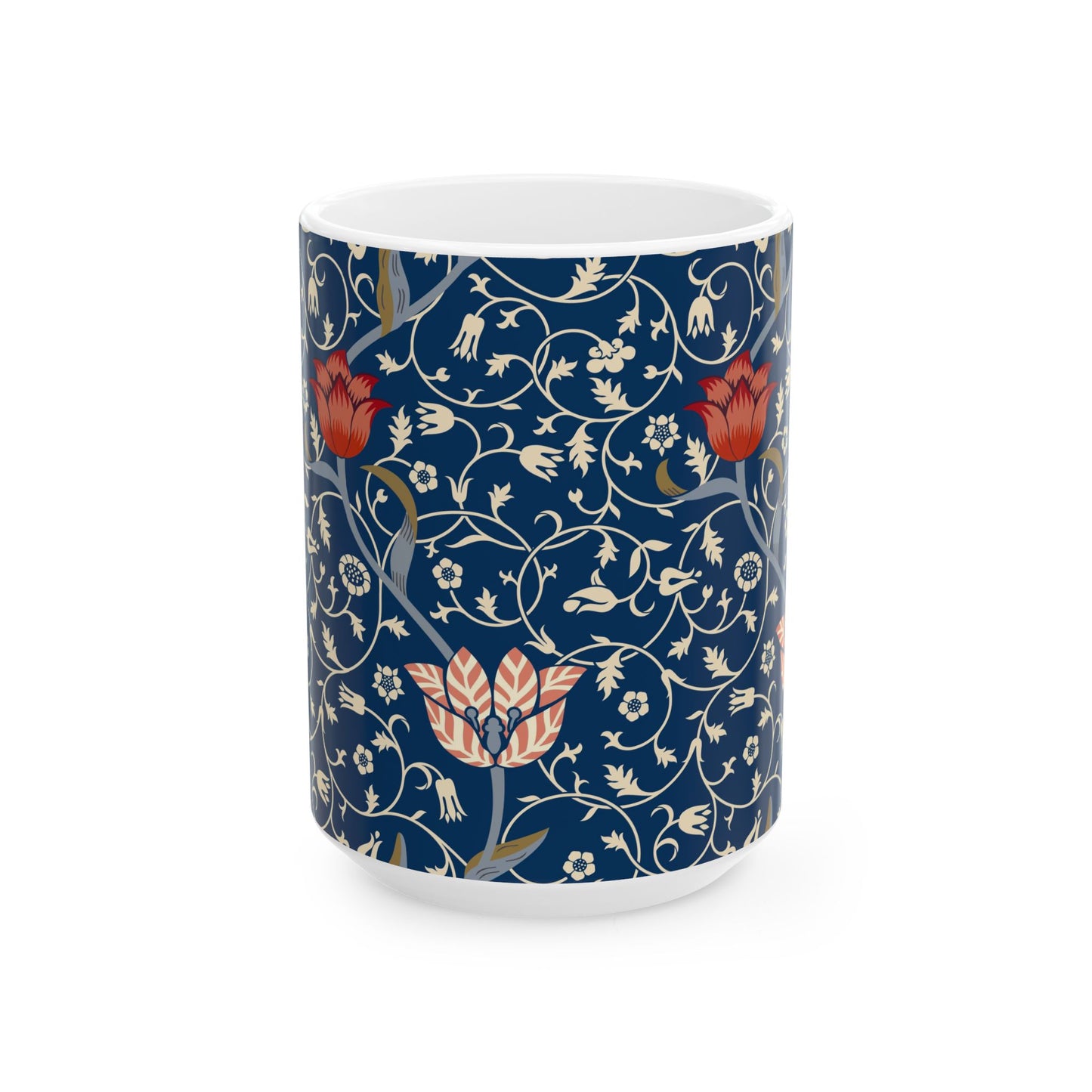A ceramic mug with a floral pattern and a white handle featuring a blue. white, red and pink pattern design called Medway by William Morris & Co