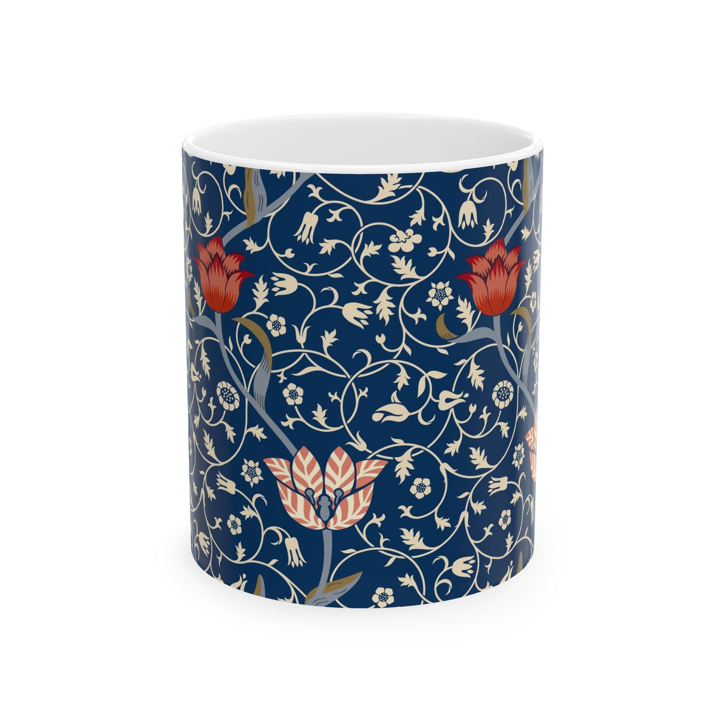 A ceramic mug with a floral pattern and a white handle featuring a blue. white, red and pink pattern design called Medway by William Morris & Co