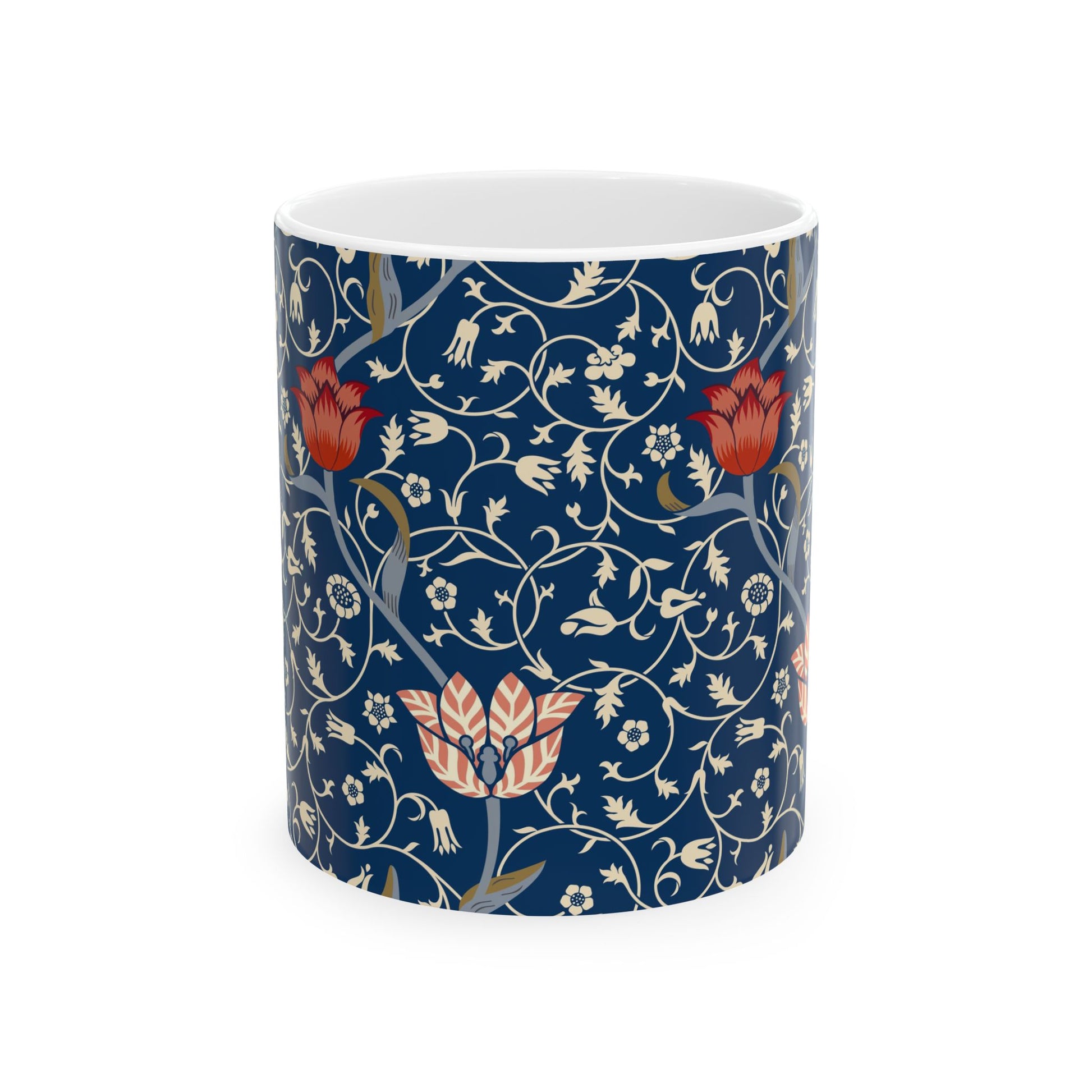 A ceramic mug with a floral pattern and a white handle featuring a blue. white, red and pink pattern design called Medway by William Morris & Co
