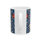 A ceramic mug with a floral pattern and a white handle featuring a blue. white, red and pink pattern design called Medway by William Morris & Co