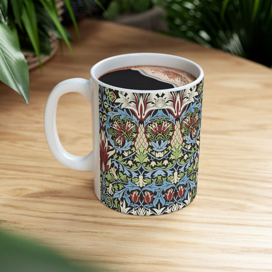 A ceramic mug with a floral and geometric pattern inspired by William Morris  & Co in a floral pattern called Snakeshead Collection.