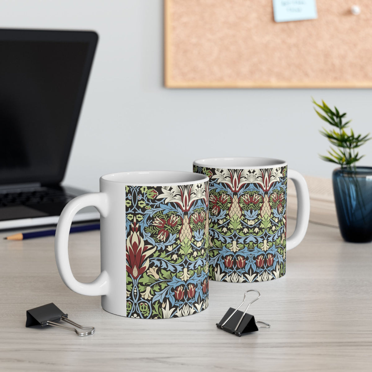 A ceramic mug with a floral and geometric pattern inspired by William Morris  & Co in a floral pattern called Snakeshead Collection.