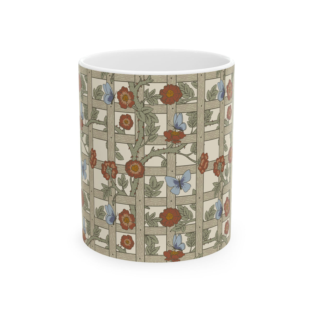 A white ceramic mug with a wrap-around Art Nouveau style print featuring a beige trellis pattern decorated with red flowers, green leaves, and blue butterflies.