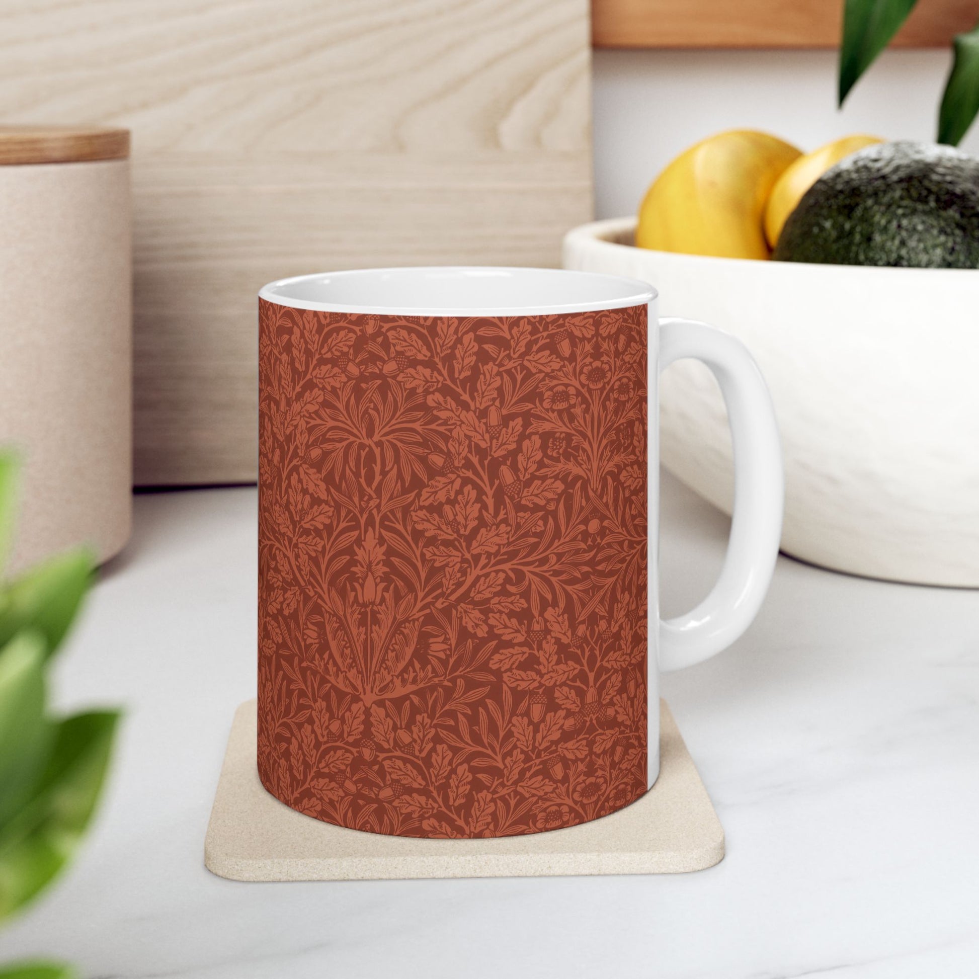 A ceramic mug with a rust-coloured floral pattern inspired by William Morris - Acorns & Oak Leaves Collection.