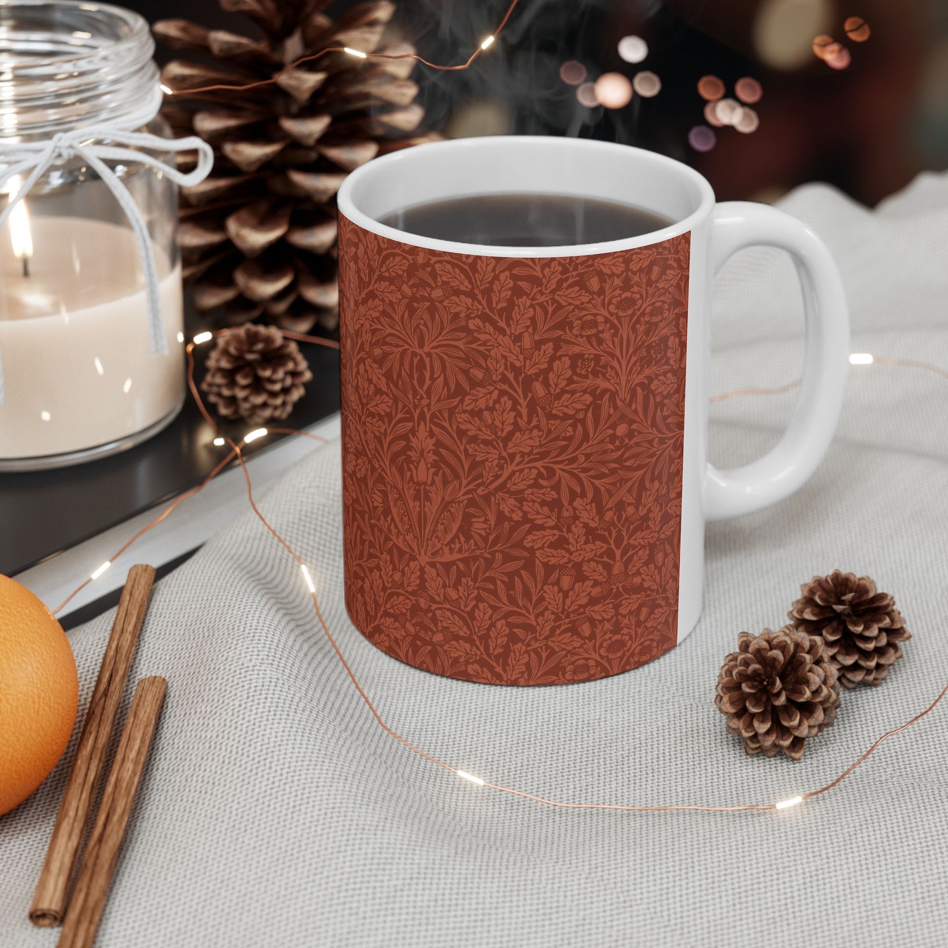 A ceramic mug with a rust-coloured floral pattern inspired by William Morris - Acorns & Oak Leaves Collection.