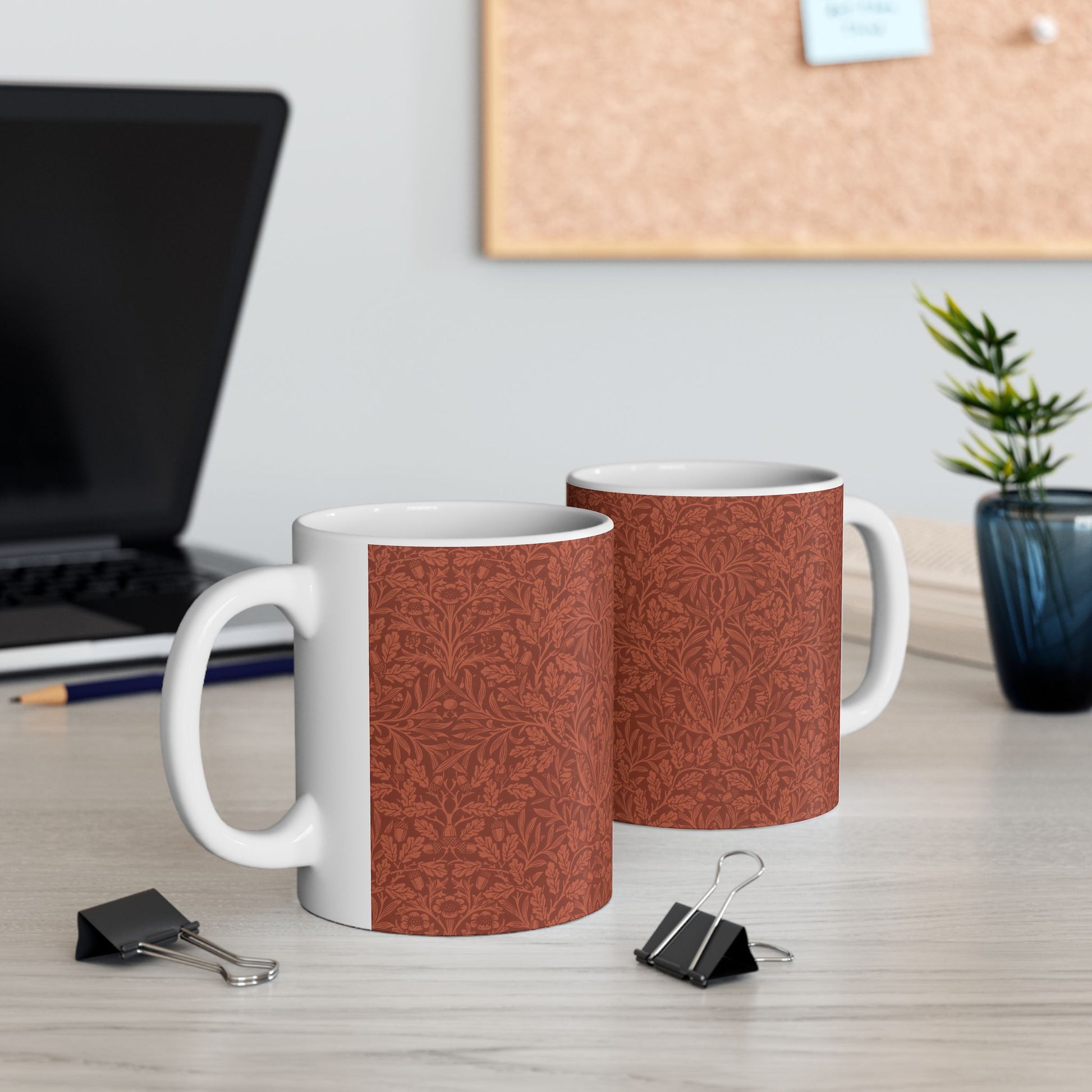 A ceramic mug with a rust-coloured floral pattern inspired by William Morris - Acorns & Oak Leaves Collection.
