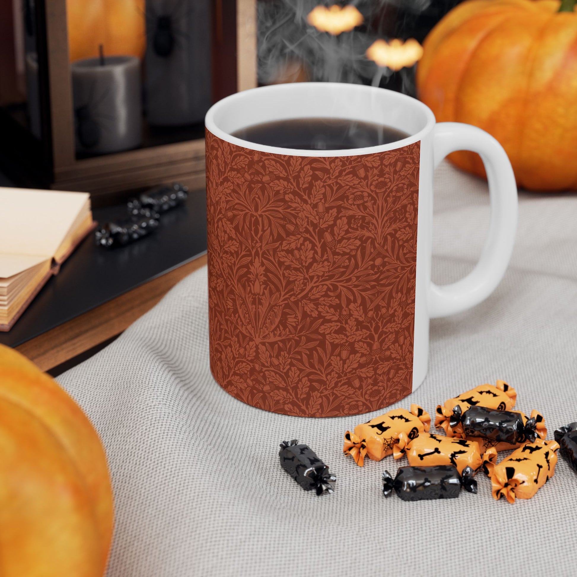 A ceramic mug with a rust-coloured floral pattern inspired by William Morris - Acorns & Oak Leaves Collection.