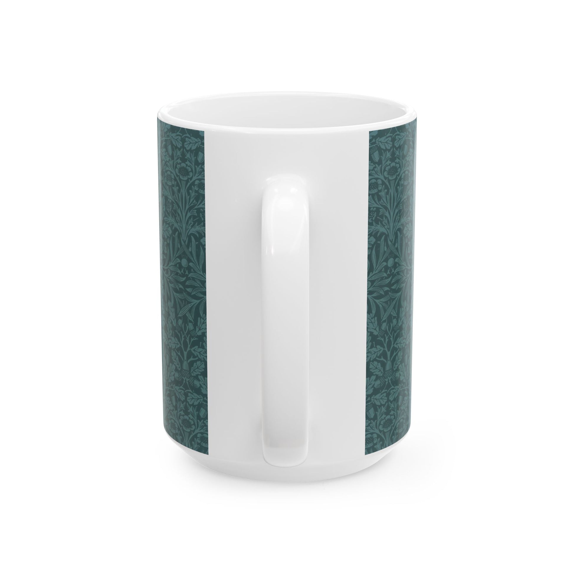 A ceramic mug with a teal base and a white handle featuring a floral and acorn pattern design, inspired by William Morris.