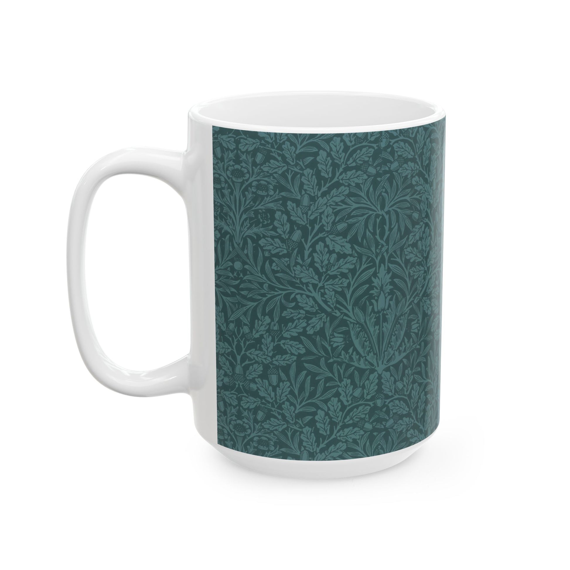A ceramic mug with a teal base and a white handle featuring a floral and acorn pattern design, inspired by William Morris.