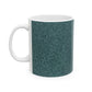 A ceramic mug with a teal base and a white handle featuring a floral and acorn pattern design, inspired by William Morris.