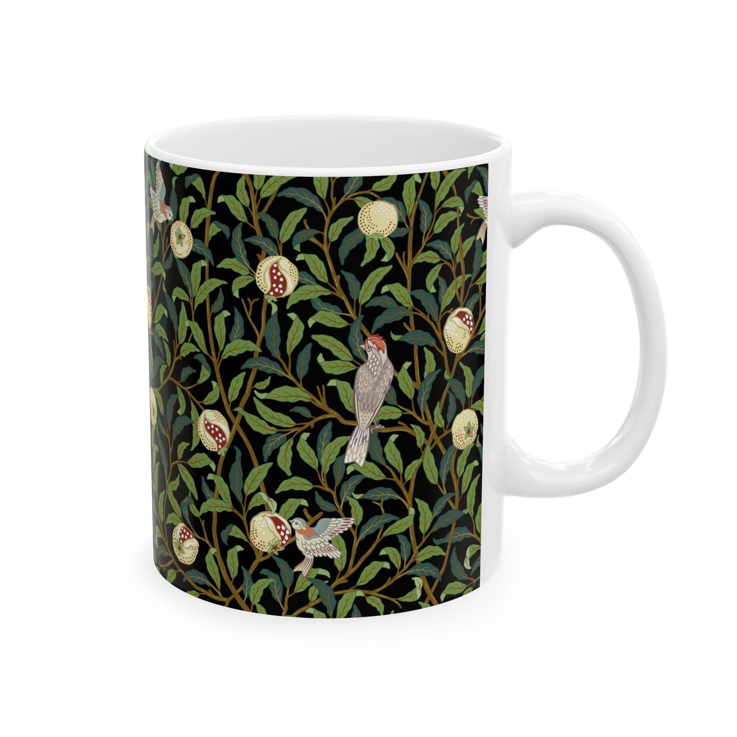 A ceramic mug with a black background featuring a floral William Morris & Co pattern of birds and pomegranates.
