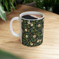 A ceramic mug with a black background featuring a floral William Morris & Co pattern of birds and pomegranates.