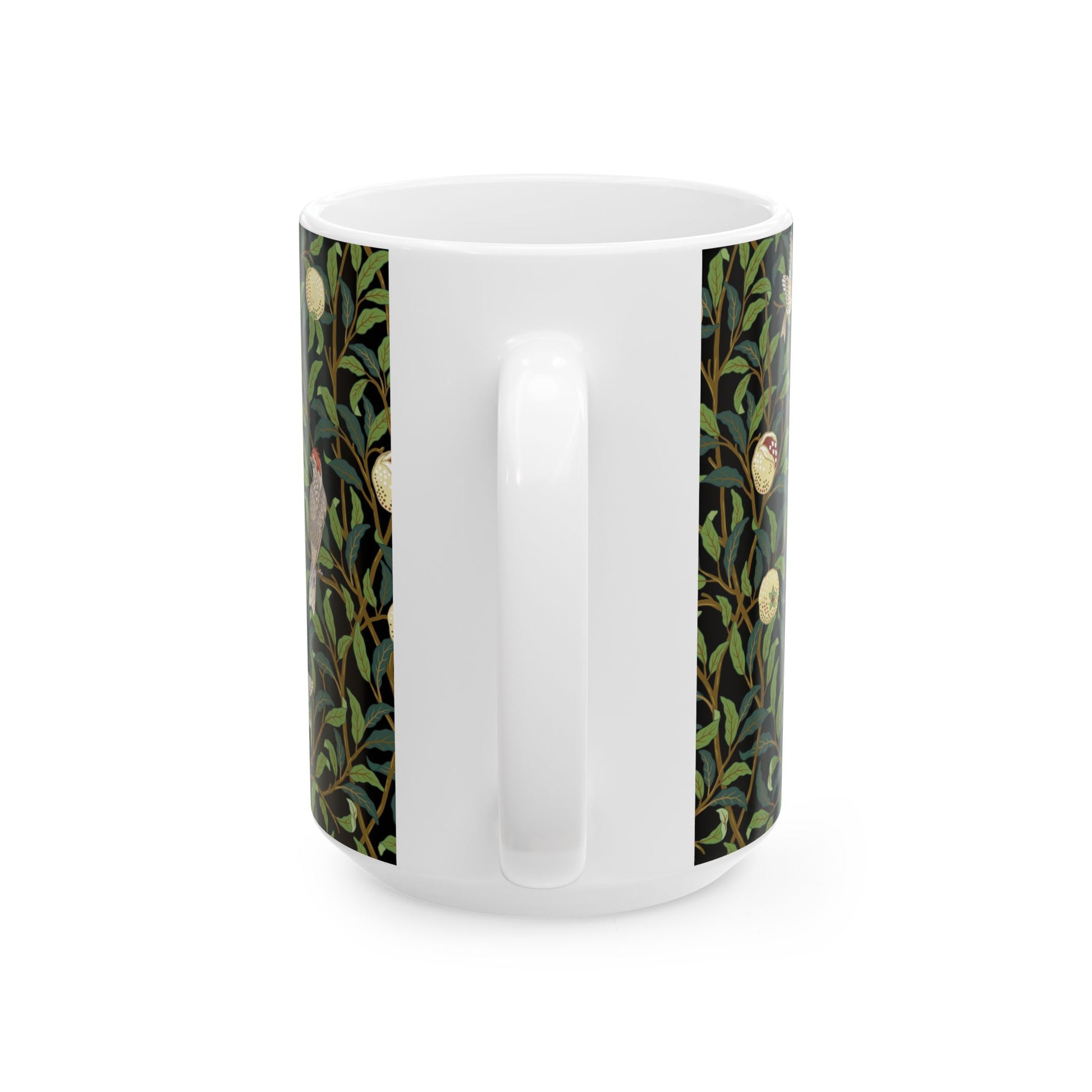 A ceramic mug with a black background featuring a floral William Morris & Co pattern of birds and pomegranates.